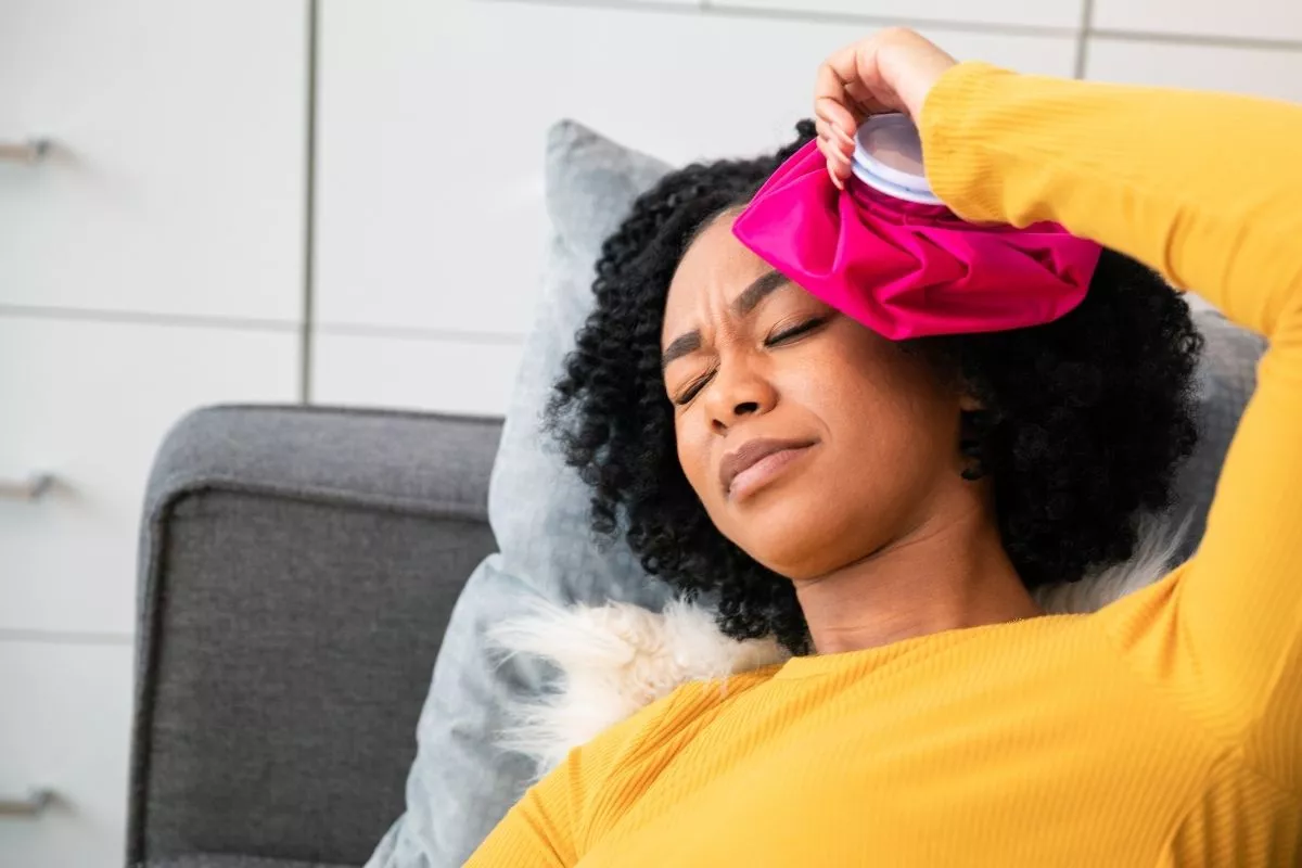 women on a coach with a migraine